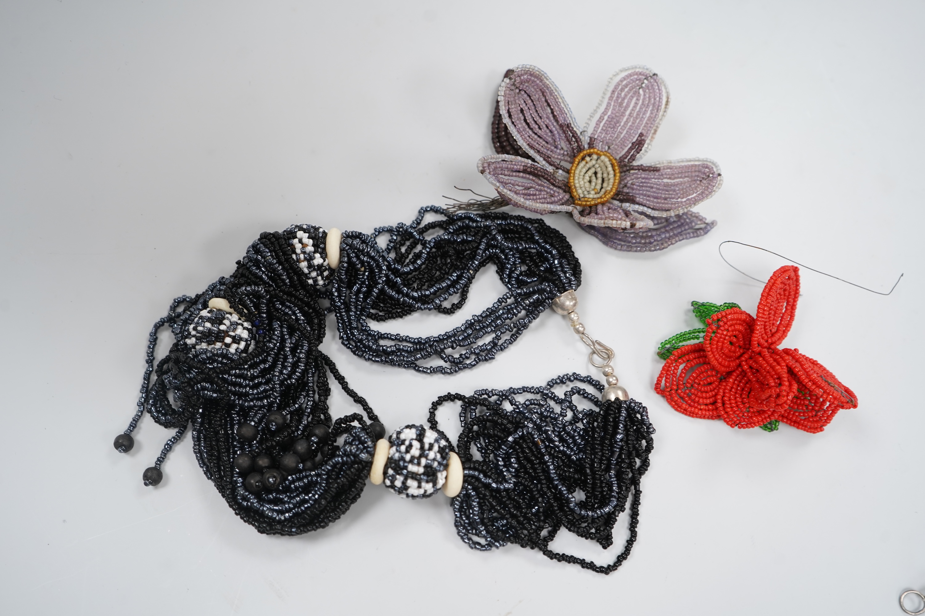 A group of beadwork floral appliqués, necklaces and an evening bag